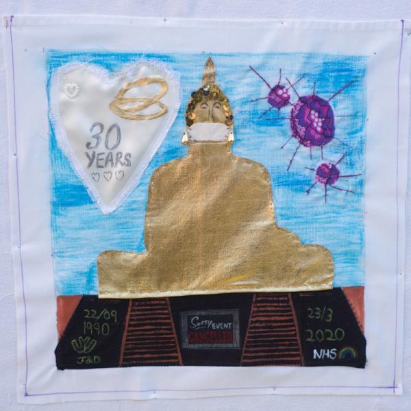 Quilt square with a golden statue stitched onto a blue background with a heart showing two gold rings and the text "30 years". Other text reads: 22/09 1990 J&D; 23/3/2020 NHS; Sorry Event Cancelled.