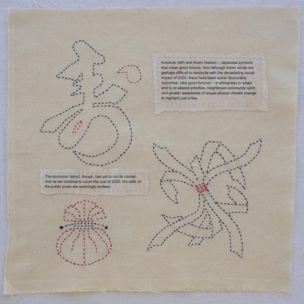 Quilt square with embroidered Japanese symbols and poignant text about good fortune and the 2020 pandemic.