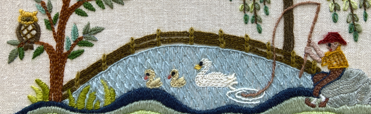 Close up of a crewel embroidery scene