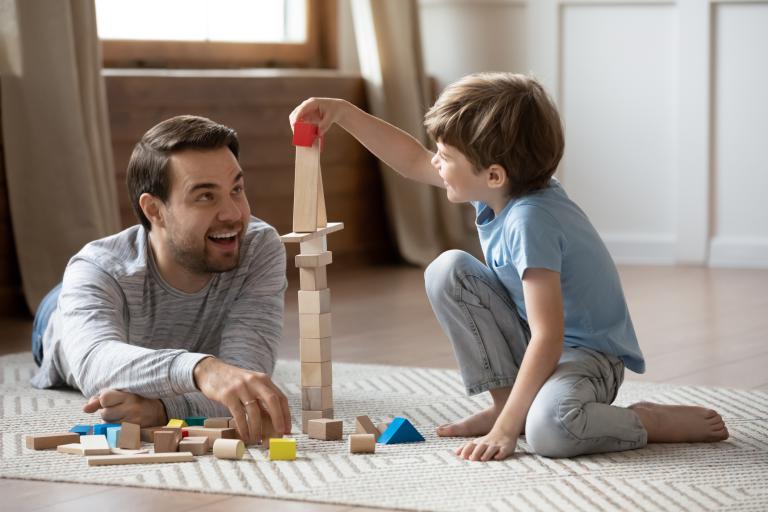 Adult and boy playing with blocks