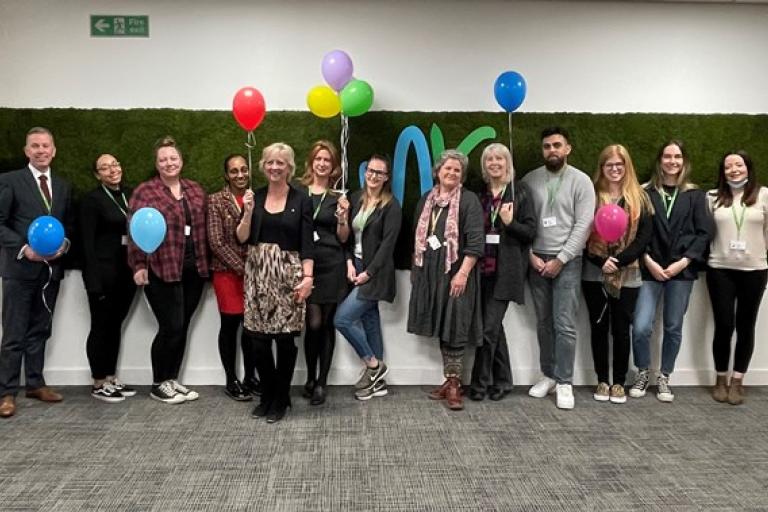 Mac Heath, Director of Children's Services and Cllr Zoe Nolan, Cabinet Member for Children and Families standing with a group of social workers