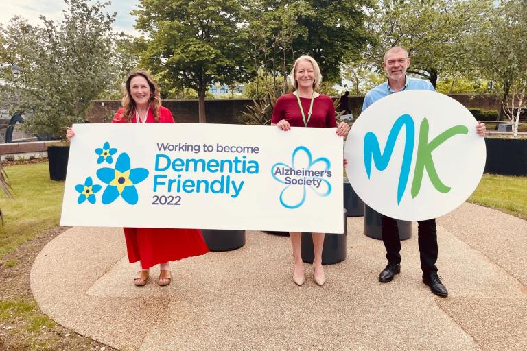 Cllr Emily Darlington and Milton Keynes Council colleagues holding a large banner