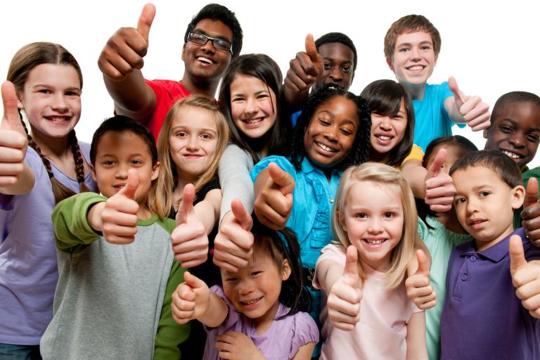 Smiling children giving thumbs up