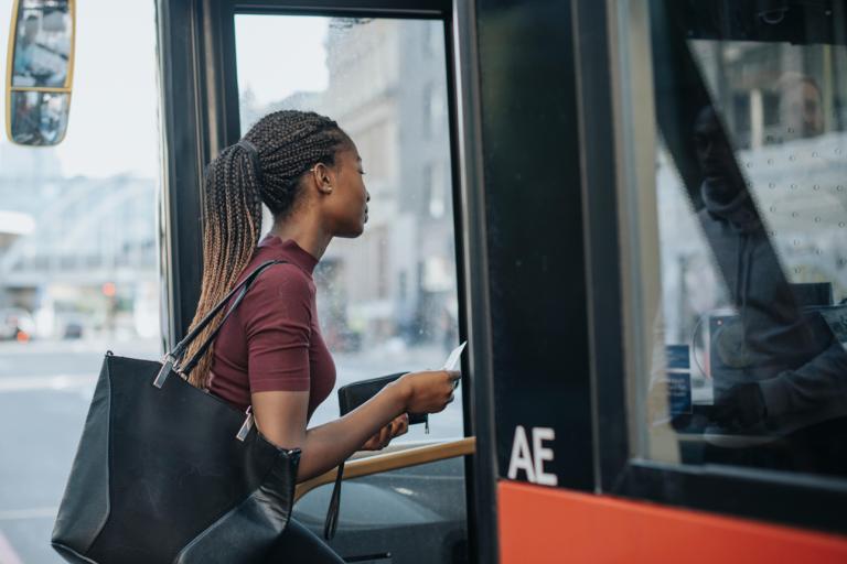 Woman getting onto a bus