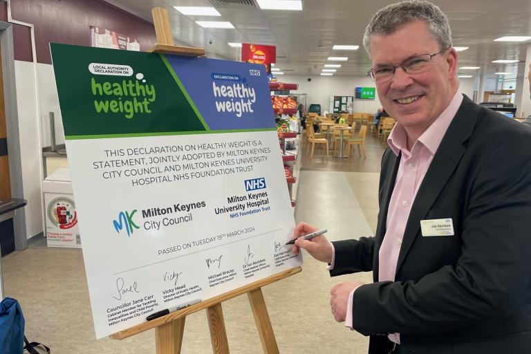 Joe Harrison, Chief Executive of Milton Keynes University Hospital signing the pledge