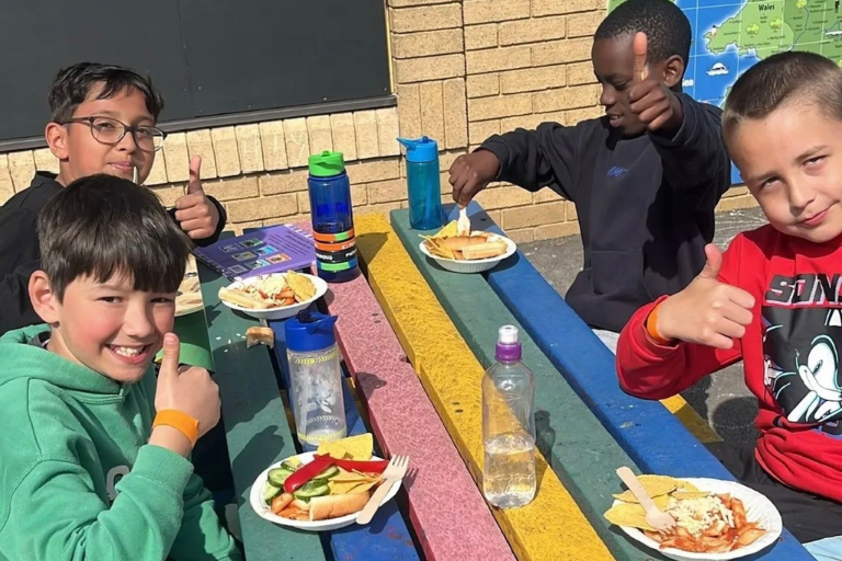 Children enjoying lunch after a sports session