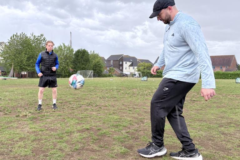 Cllr Joe Hearnshaw playing football with local teens