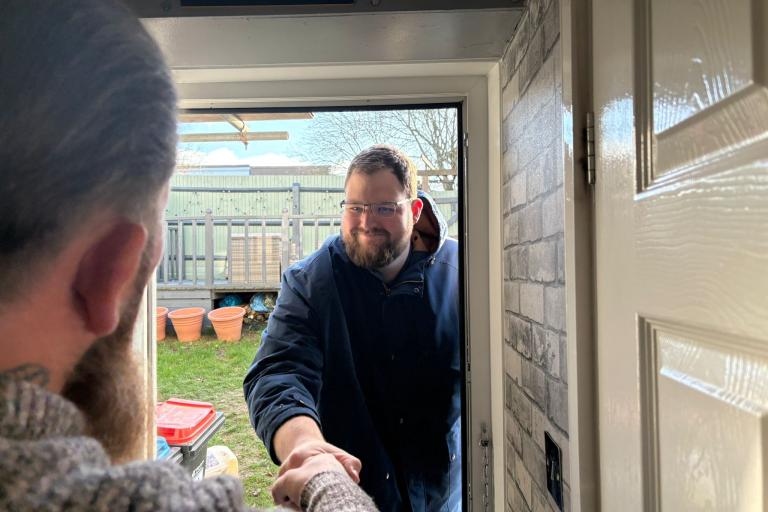 Cllr Ed Hume walking through door