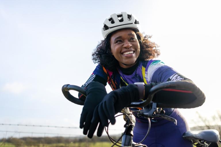 Woman cyclist on bike in winter month