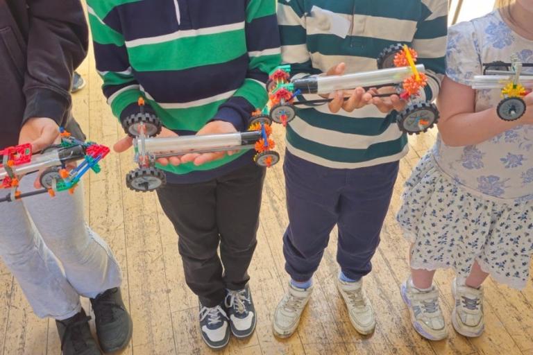 Four children holding car rockets