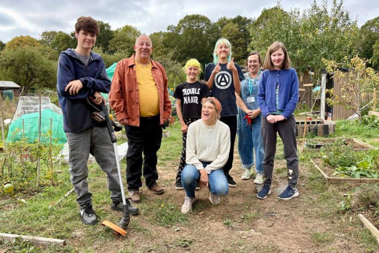 Councillor Peter Cannon with council colleagues and young people at the large allotment plot in New Bradwell