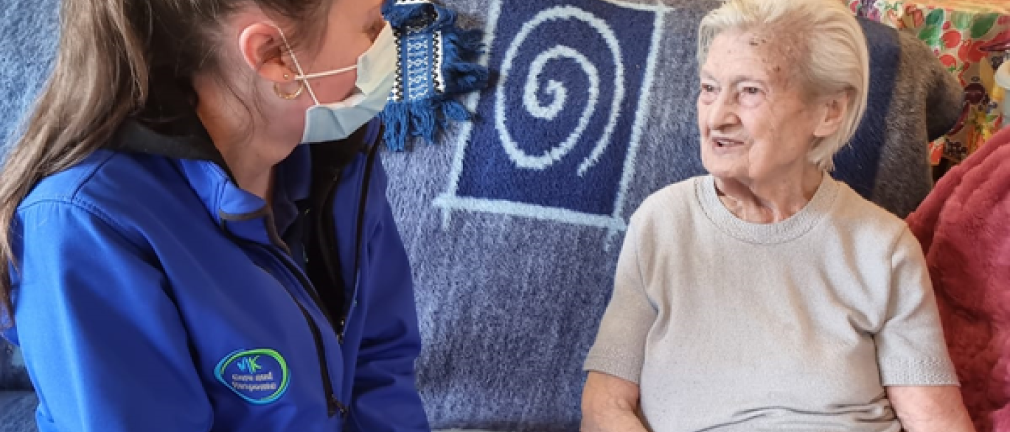 A member of the Care and Response team on a visit with a local resident