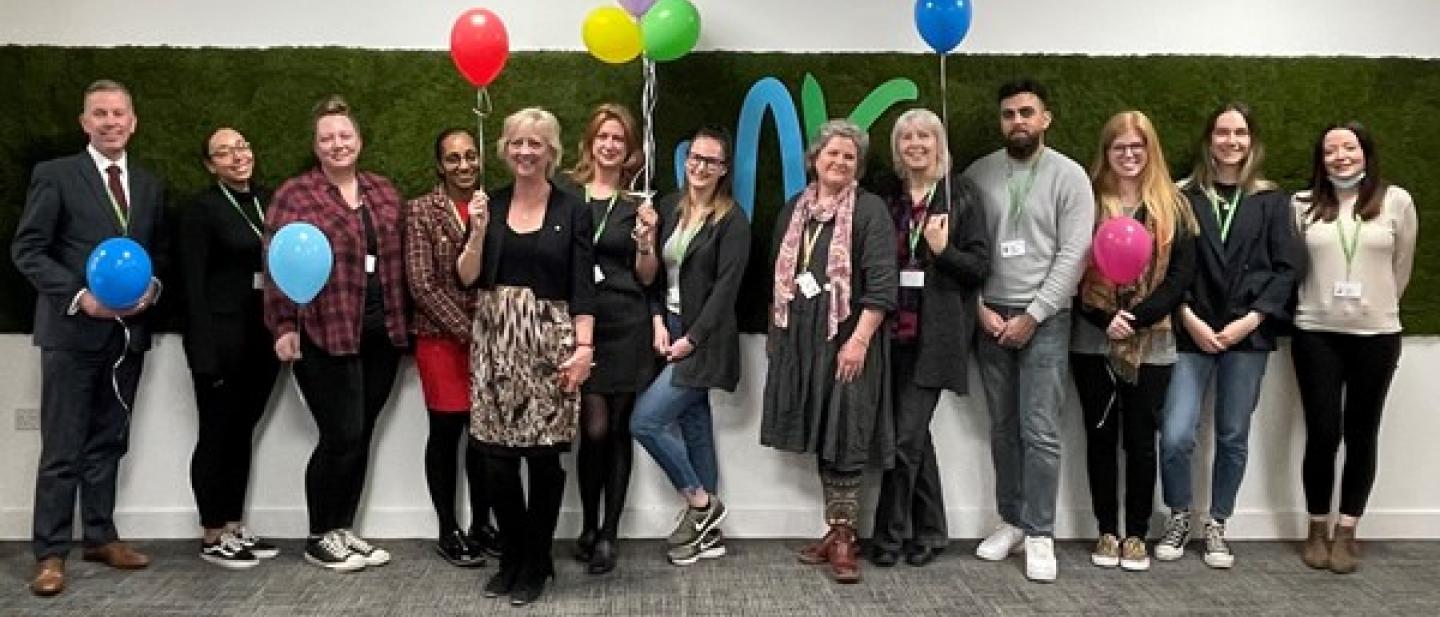 Mac Heath, Director of Children's Services and Cllr Zoe Nolan, Cabinet Member for Children and Families standing with a group of social workers