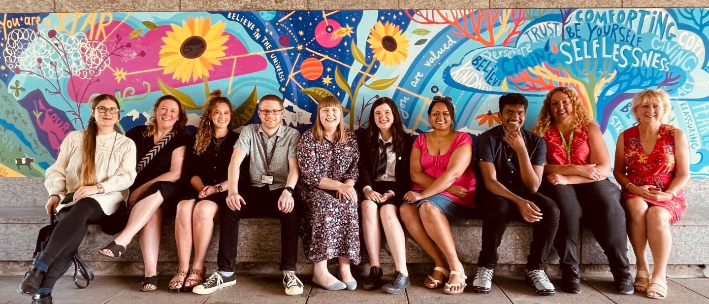 Councillors with young people, local partners and the artist by the mural
