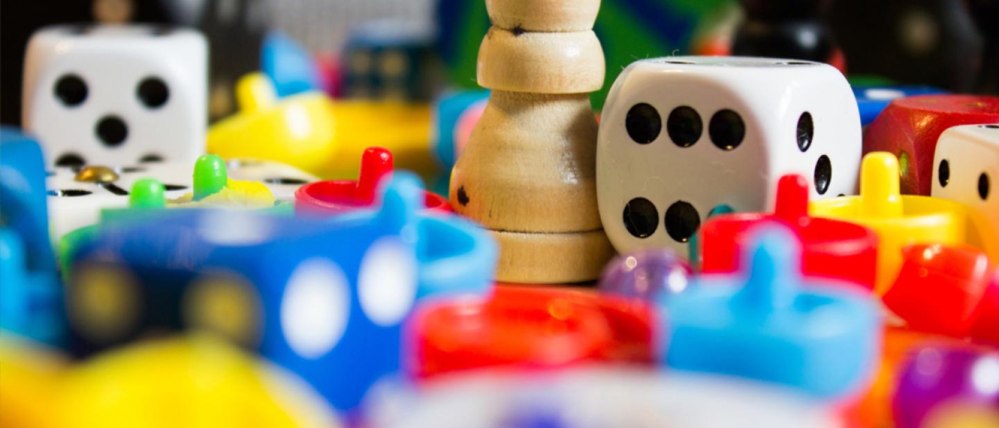 Many games counters, dice and board game pieces.