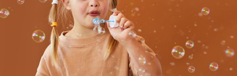 girl blowing bubbles