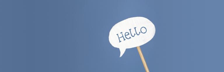 A speech bubble on a stick saying 'Hello!'