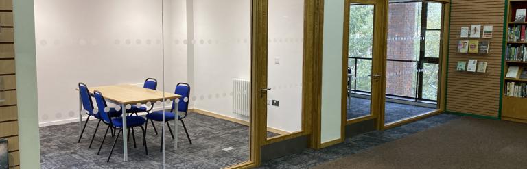 Two meeting rooms at Central Library with glass walls towards the library space.