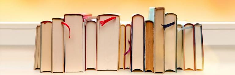 A row of books viewed from the bottom.