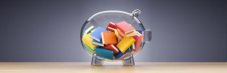 A clear glass piggy bank with mini books inside.