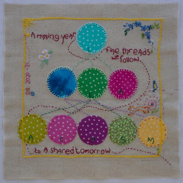 Quilt square with bright fabric circles connected by embroidery. Text reads "A missing year ... fine threads we follow ...to a shared tomorrow" 2020-2021.