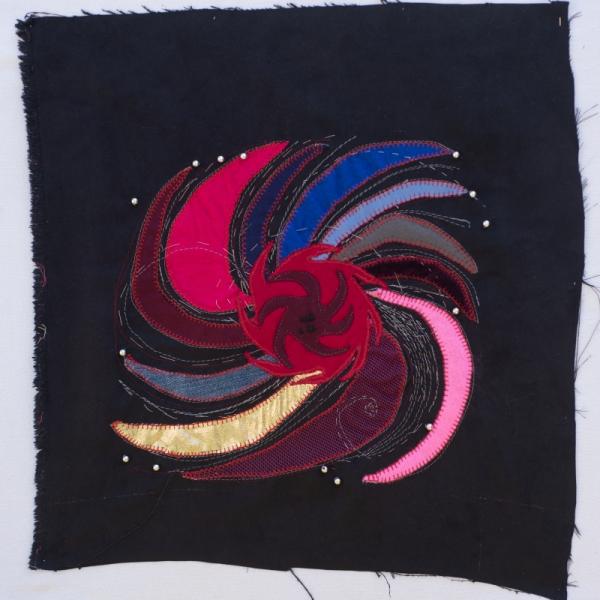 A swirl of fabrics making a pinwheel pattern.