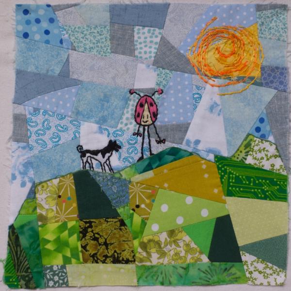 Quilt square using different patterned fabric to make a countryside landscape with the sun shining and a ladybird and dog.