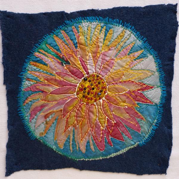 Quilt square showing a fabric flower.