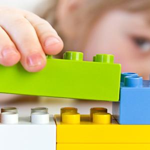 Girl building with Duplo bricks