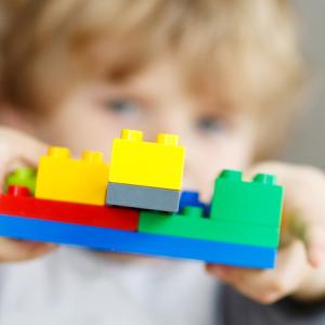 Child holding up some building bricks