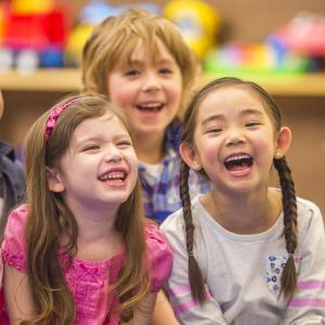 Children smiling and listening to a story