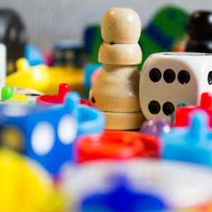 Many games counters, dice and board game pieces.