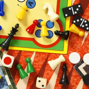 A jumble of board game pieces and boards.
